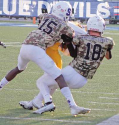 Robert Franklin Jr. and Austin Pawlowski tackle the Clay ball carrier.