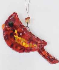 Pictured is an example of the glass cardinals that can be created at Copper Moon Studio.