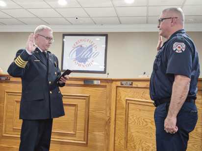 Assistant Fire Chief Dave Moore swears in full-time firefighter/ EMT Ryan Goodrick. Mr. Goodrick had been a parttime firefighter.