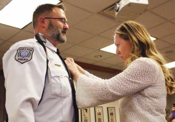 Following the oath of office, administered by village solicitor Paul Skaff, Chief Jim Piotrowski is pinned by his wife Amy. At the April 16 meeting, village council removed the moniker interim from Chief Piotrowski’s title.