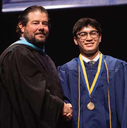 Derek Camacho is pictured with St. John’s Jesuit High School Principal Brendan Malone, Class of 2001.