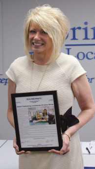 Kristina White accepts a commendation from the Journal.