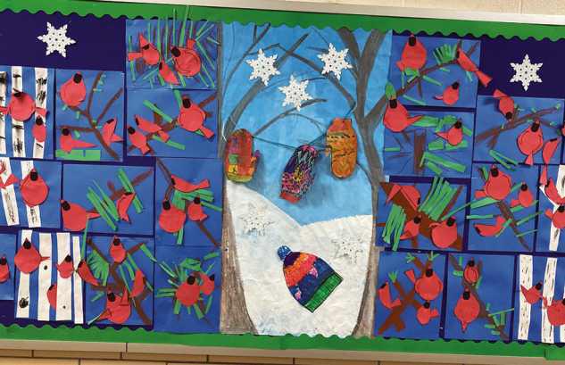 This photo is of student work from Dorr Elementary students who have been learning about wildlife artist Charley Harper. The second grade students made winter cardinals.